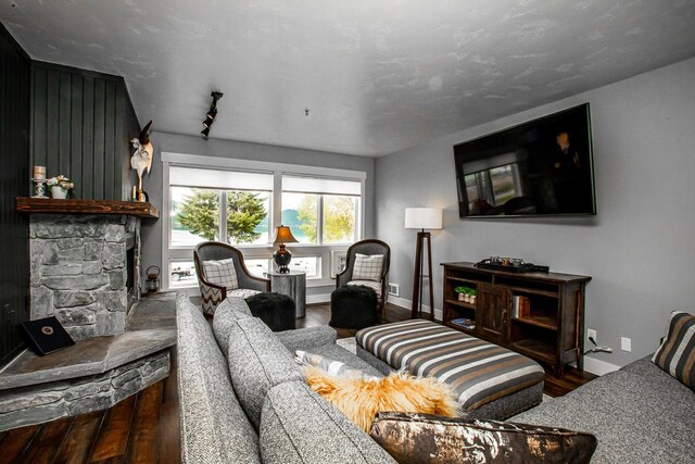 1400 Wisconsin Ave Unit 212, Whitefish, MT 59937 - living room with wood finished floors and a stone fireplace