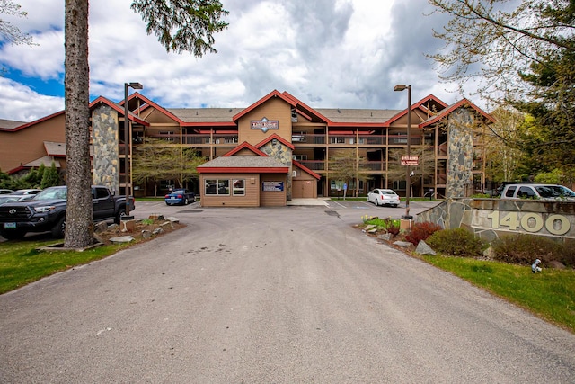 view of building exterior with uncovered parking