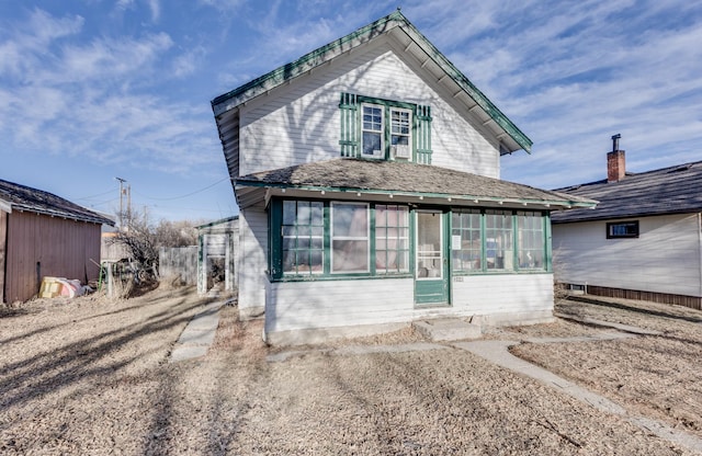 view of front facade with a sunroom