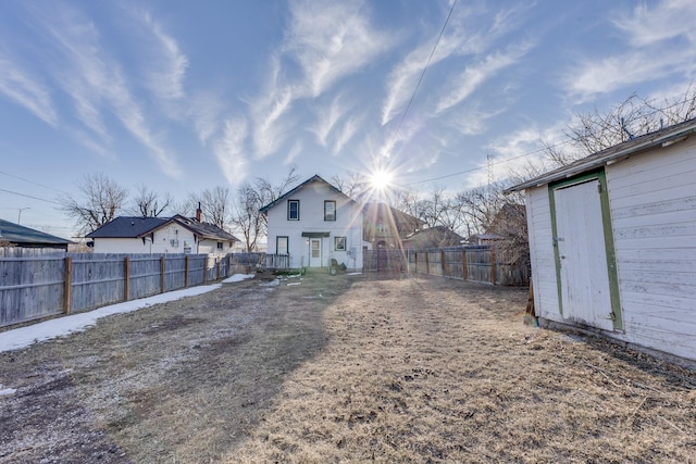 view of yard featuring an outbuilding and a fenced backyard