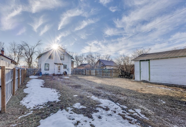 exterior space featuring a fenced backyard and an outbuilding