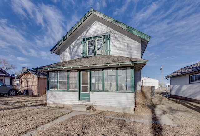 view of front of house featuring central AC unit and a sunroom