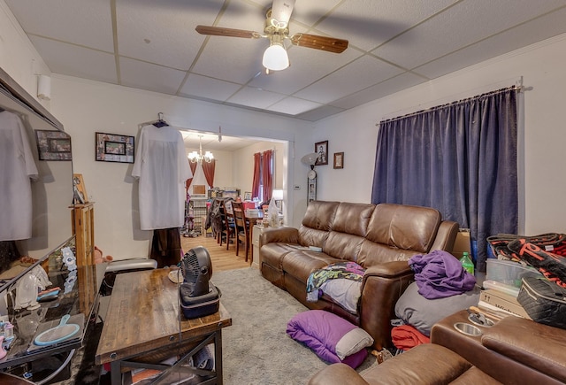 living room with a paneled ceiling, wood finished floors, and ceiling fan with notable chandelier