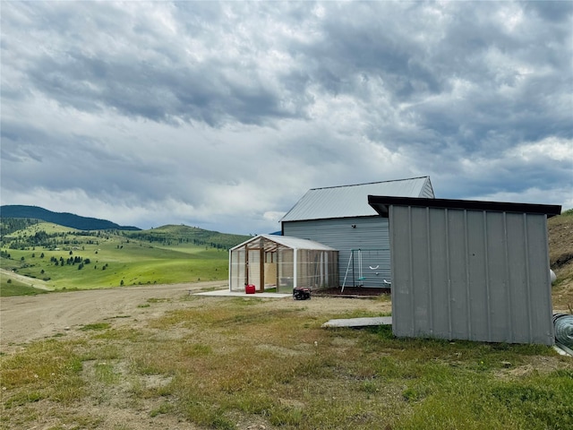 exterior space featuring a mountain view and an outbuilding