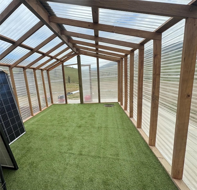 unfurnished sunroom with vaulted ceiling