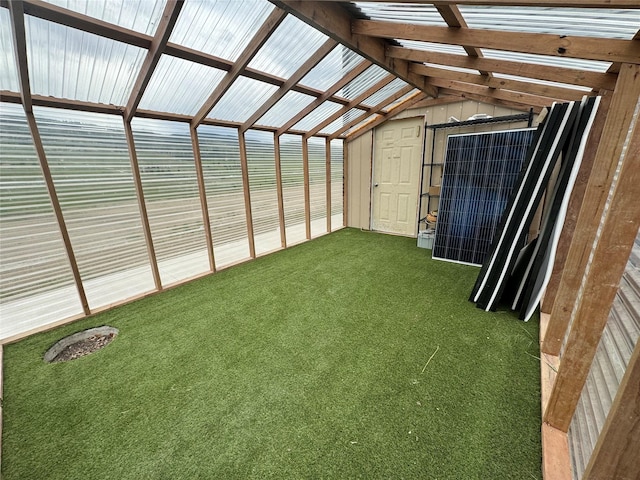 unfurnished sunroom with vaulted ceiling