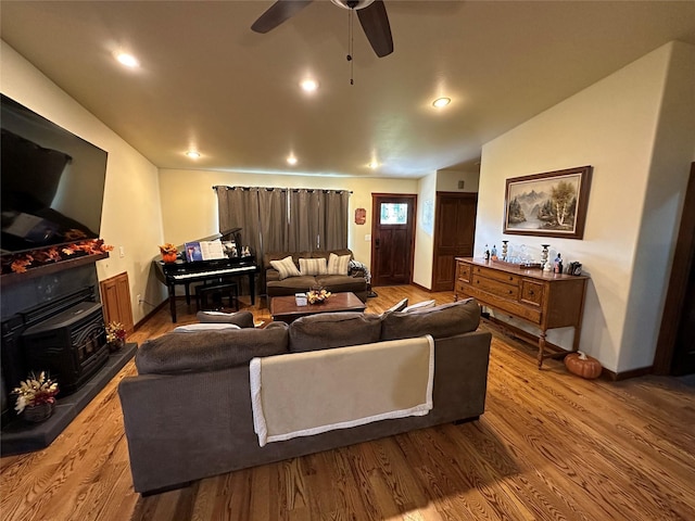 316 3rd Ave, Saint Ignatius, MT 59865 - living room featuring a wood stove, dark wood-style flooring, a ceiling fan, recessed lighting, and lofted ceiling