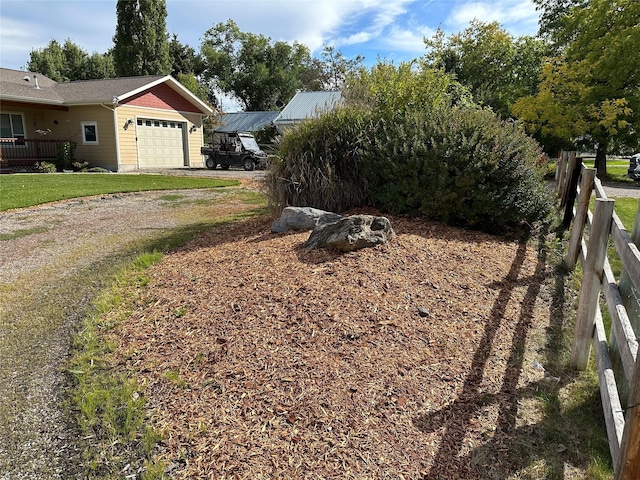 316 3rd Ave, Saint Ignatius, MT 59865 - view of yard featuring an attached garage and driveway
