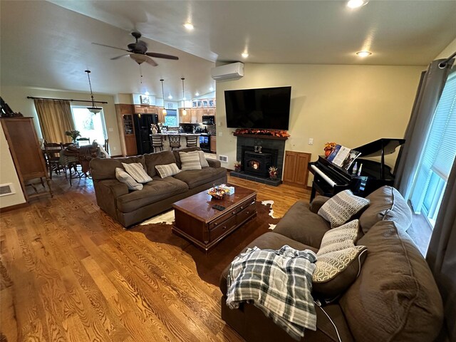 316 3rd Ave, Saint Ignatius, MT 59865 - living area featuring ceiling fan, vaulted ceiling, an AC wall unit, and light wood-style floors