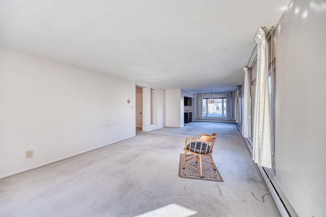 interior space featuring a baseboard radiator, a textured ceiling, and carpet