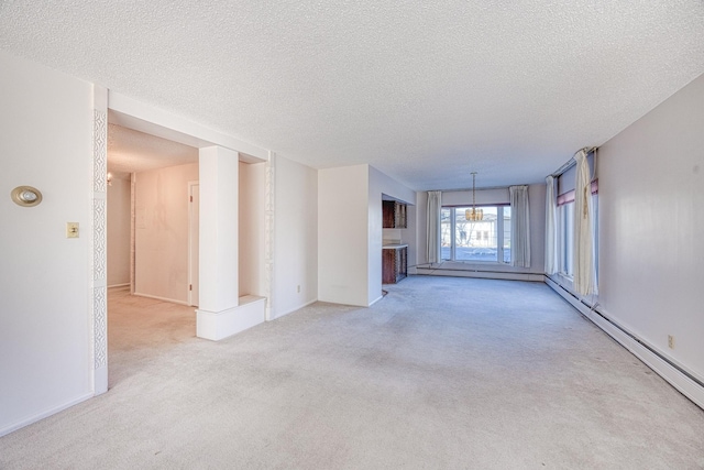 unfurnished living room featuring carpet, a textured ceiling, a baseboard heating unit, and a notable chandelier