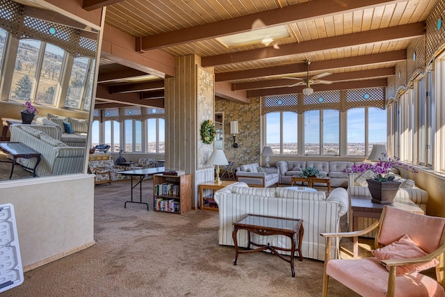 living area with carpet floors, beam ceiling, wooden ceiling, and ceiling fan