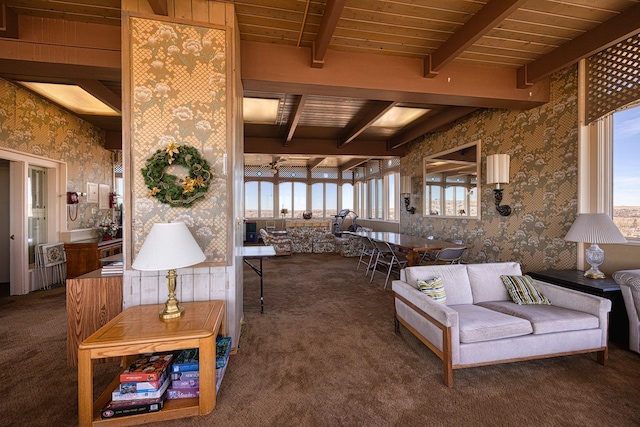 carpeted living area with wooden ceiling, wallpapered walls, plenty of natural light, and beamed ceiling