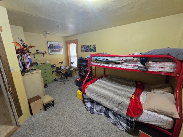 bedroom with a textured ceiling and carpet