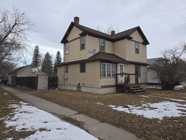 exterior space featuring a chimney and a deck