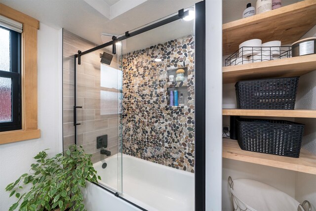 full bathroom with shower / bath combination with glass door