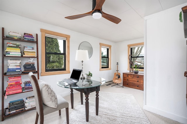 office area with carpet floors, baseboards, and a ceiling fan