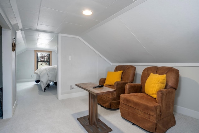 sitting room with vaulted ceiling, carpet floors, and baseboards