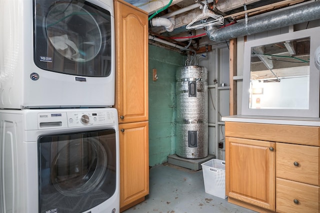 laundry area with stacked washer and dryer, heat pump water heater, and cabinet space