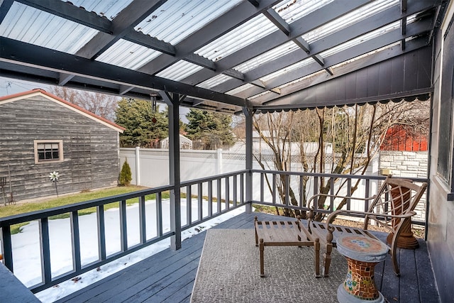 wooden deck with an outdoor structure and fence