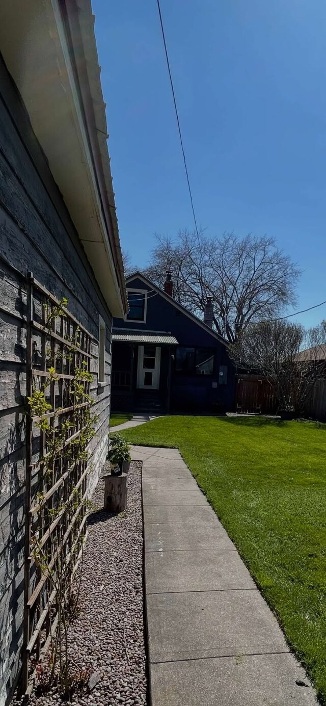 view of property exterior with a lawn