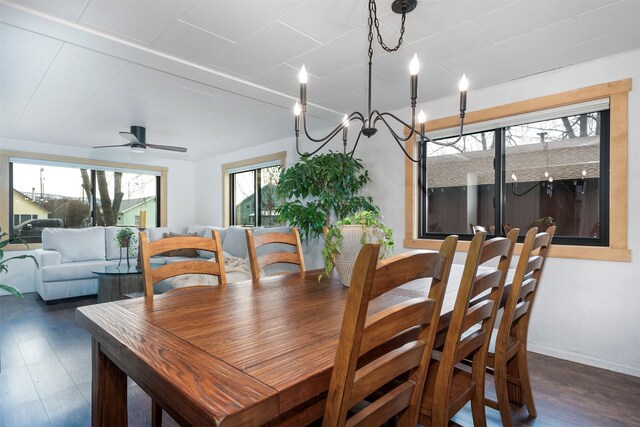dining area with wood finished floors, a ceiling fan, and baseboards
