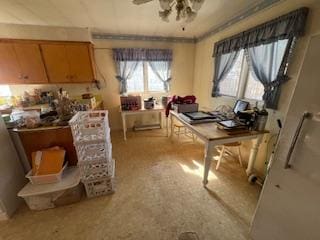 office space with crown molding, light colored carpet, and ceiling fan