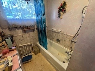 bathroom with shower / tub combo, visible vents, and tile patterned floors