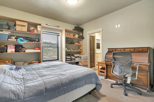 bedroom with light carpet and a textured ceiling