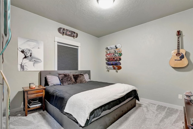 bedroom with carpet floors, baseboards, and a textured ceiling