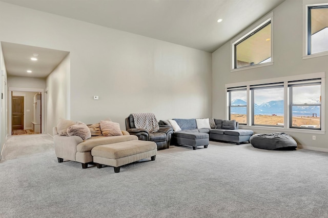 living room featuring light carpet, high vaulted ceiling, baseboards, and recessed lighting