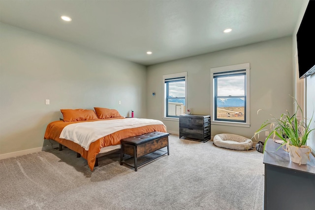 bedroom with recessed lighting, baseboards, and light colored carpet