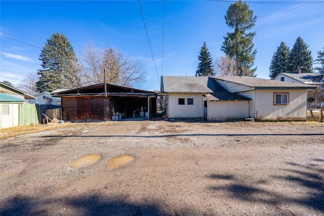 back of house featuring fence