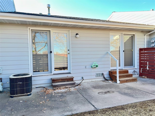 property entrance with visible vents and central AC unit