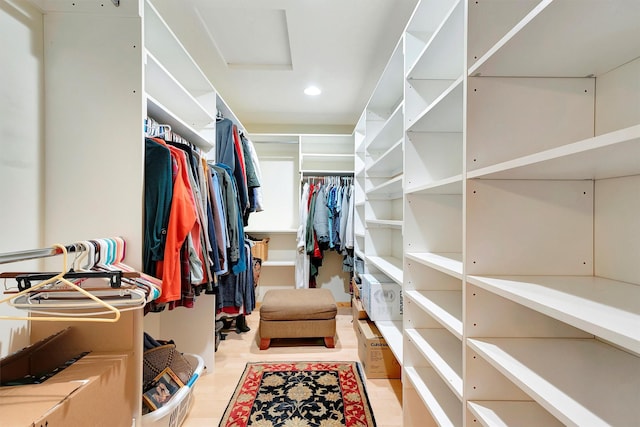 spacious closet featuring attic access