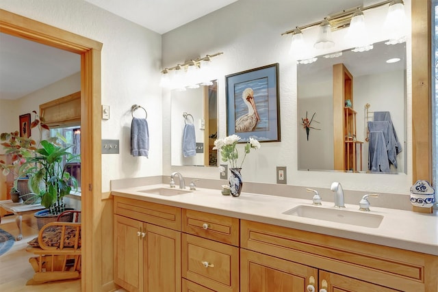 bathroom featuring a sink and double vanity