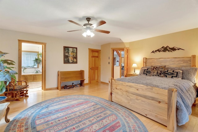 bedroom featuring a ceiling fan, light wood-type flooring, baseboards, and ensuite bathroom