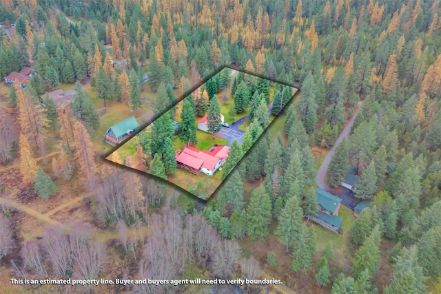 birds eye view of property with a wooded view