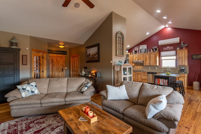 living area featuring ceiling fan, light wood-style flooring, vaulted ceiling, and recessed lighting