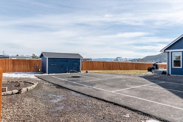 exterior space featuring a fenced backyard and a shed