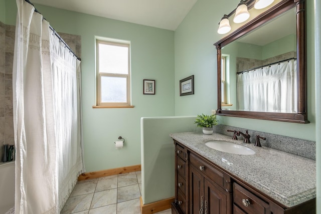 bathroom with curtained shower, vanity, and tile patterned floors