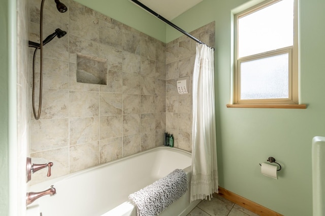 full bathroom featuring baseboards, shower / bath combo with shower curtain, and tile patterned floors