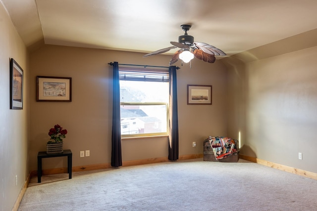 interior space featuring carpet, vaulted ceiling, and baseboards