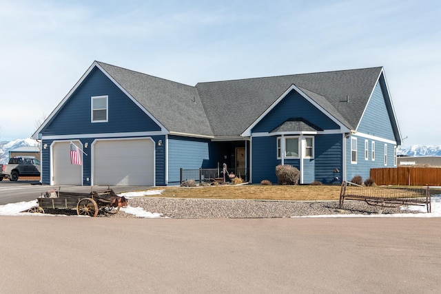 view of front of house featuring a garage and fence