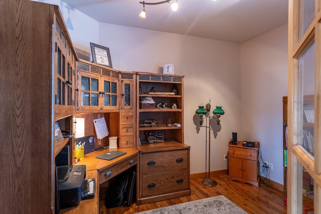 office featuring wood finished floors and baseboards