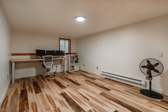 office area featuring a baseboard heating unit, baseboards, and wood finished floors