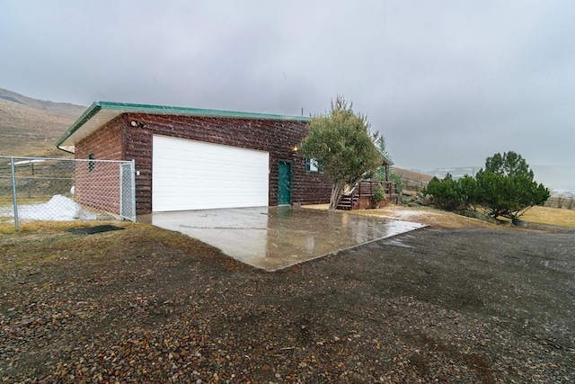 exterior space with fence and concrete driveway