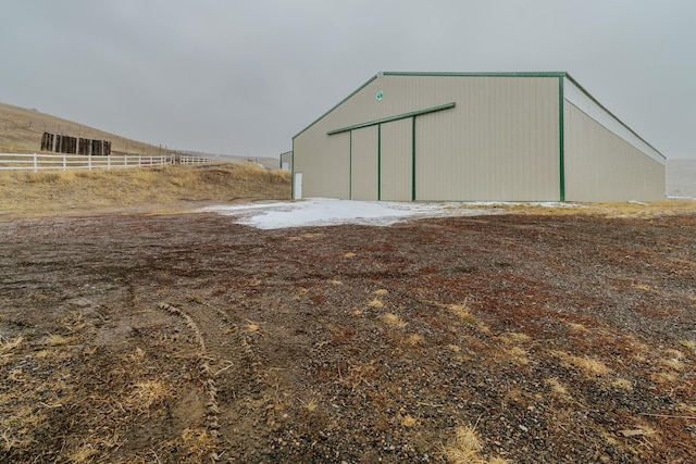 view of pole building featuring fence