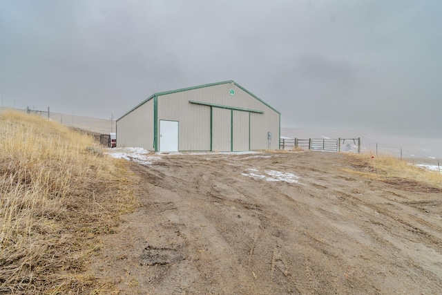 view of pole building featuring fence