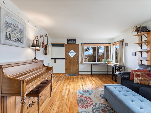 living area featuring baseboard heating and light wood-style flooring